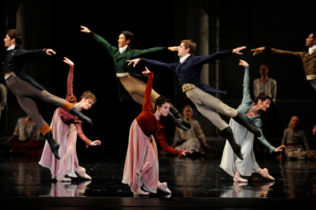 Arms out, four aristocrat men leap right; three aristocrat women lean left, knees bent, right foot pointed behind, right arms up