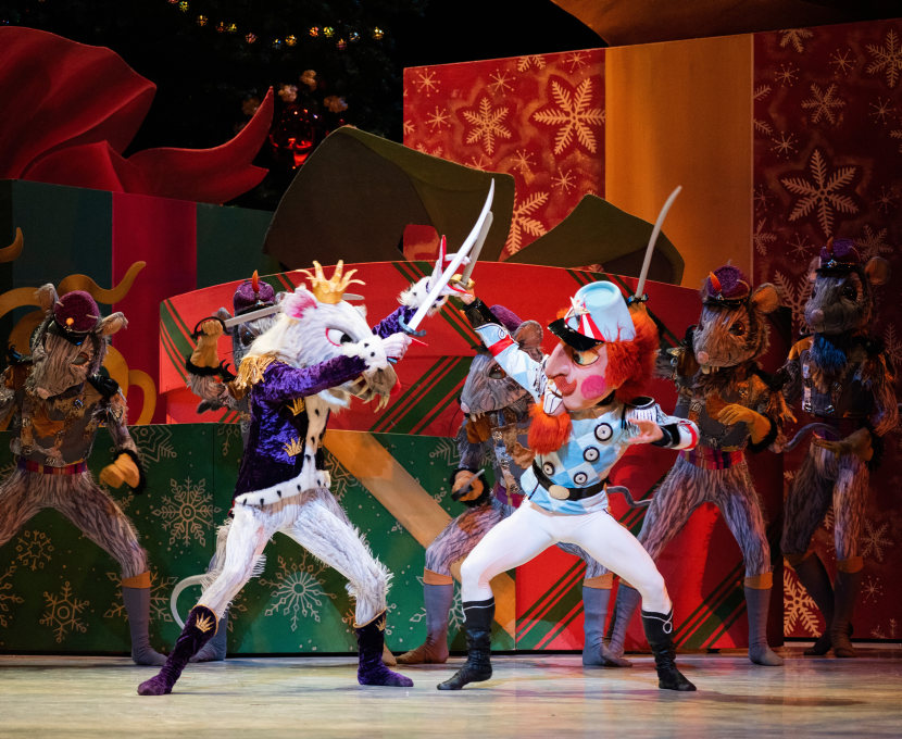 The Mouse King and Nutcracker lock blades in a swordfight.