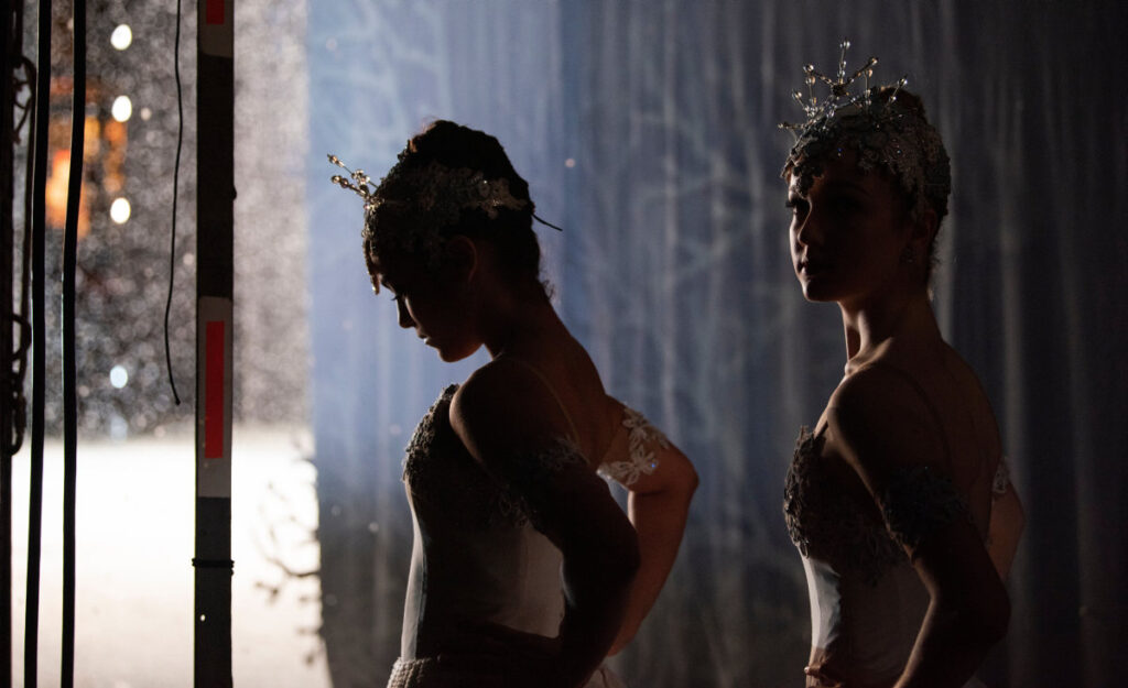 Ballerinas in snowflake costumes waiting in the wings to go on the War Memorial Stage.