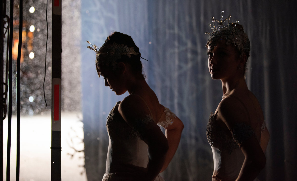 Ballerinas in snowflake costumes waiting in the wings to go on the War Memorial Stage.
